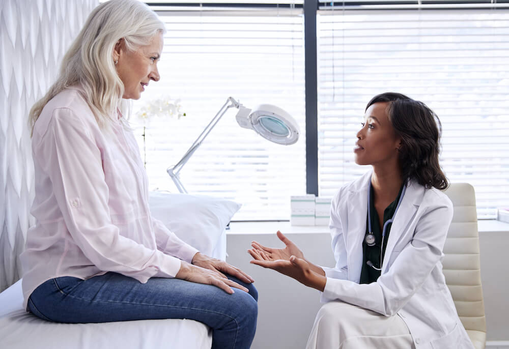 Woman consulting a vein doctor about her varicose veins and Microphlebectomy treatment