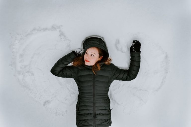Woman laying down on snow